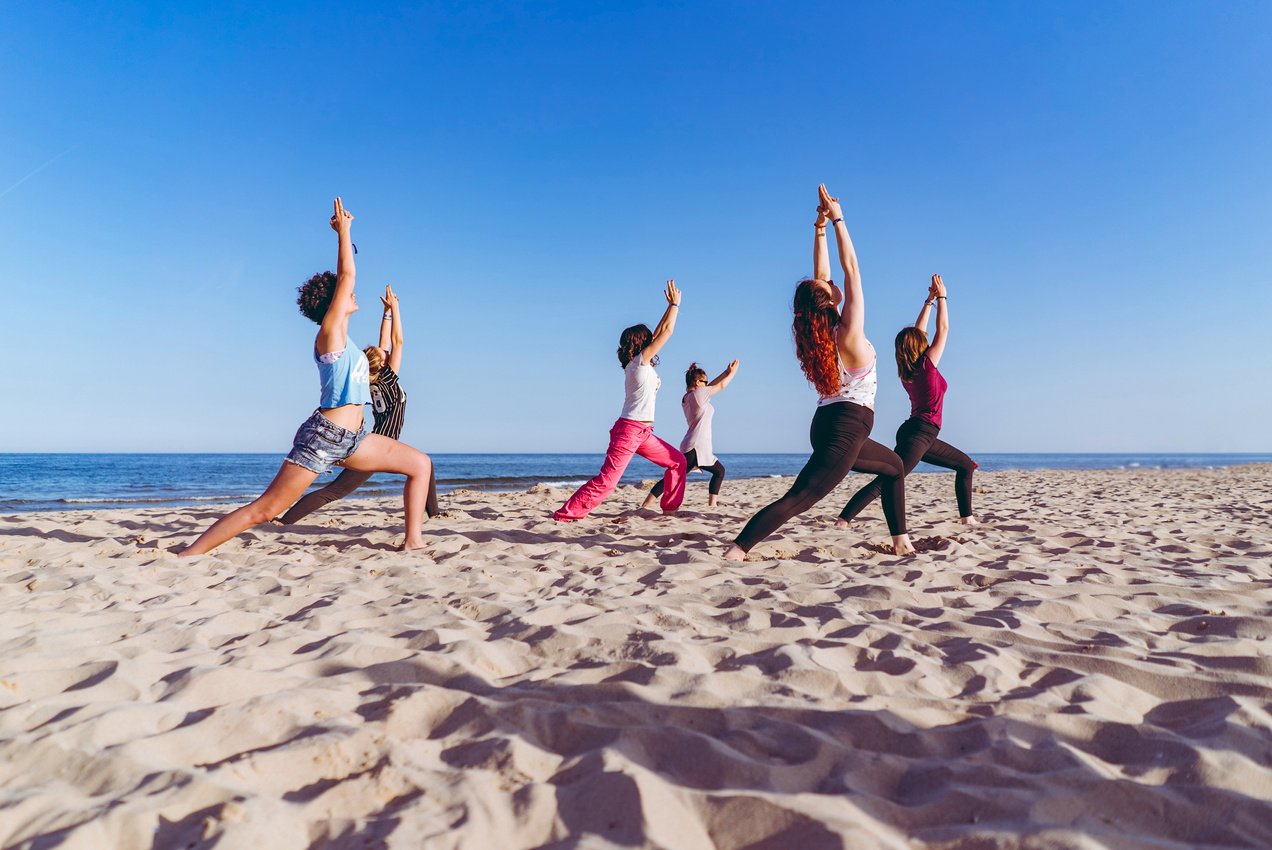 Group yoga on the beach